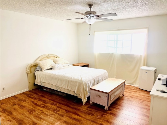 7260 Richfield St Unit 305, Paramount, CA 90723 - bedroom featuring a ceiling fan, a textured ceiling, and wood finished floors