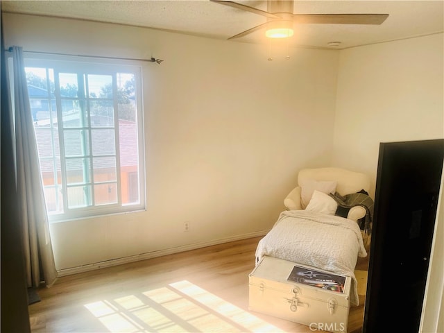 7260 Richfield St Unit 305, Paramount, CA 90723 - bedroom with baseboards, multiple windows, a ceiling fan, and light wood finished floors