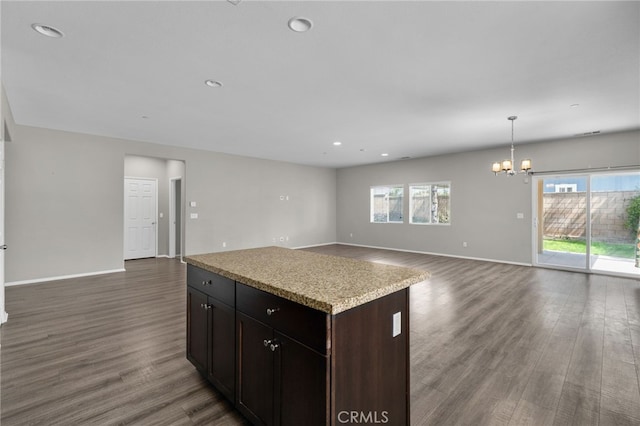 kitchen featuring dark wood-type flooring, open floor plan, plenty of natural light, and a chandelier
