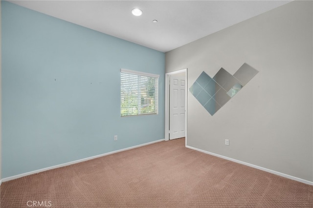 carpeted spare room with baseboards