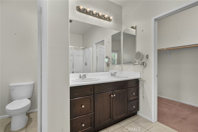 bathroom with a sink, baseboards, a shower stall, and tile patterned flooring