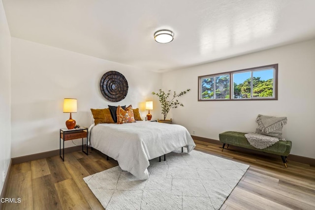 bedroom featuring baseboards and wood finished floors