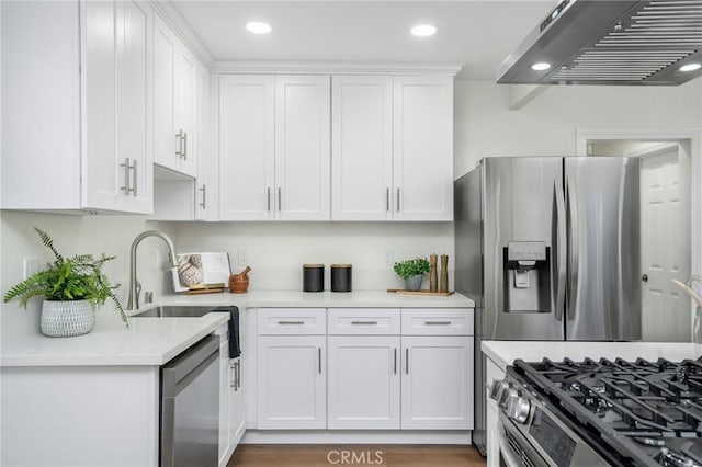 kitchen with white cabinetry, light countertops, a sink, and stainless steel appliances