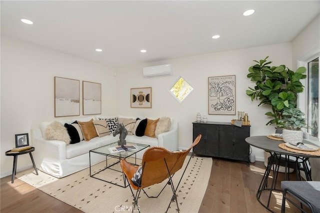 living area featuring a wall mounted air conditioner, recessed lighting, and hardwood / wood-style floors