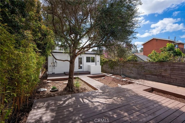 deck featuring an outdoor structure and fence