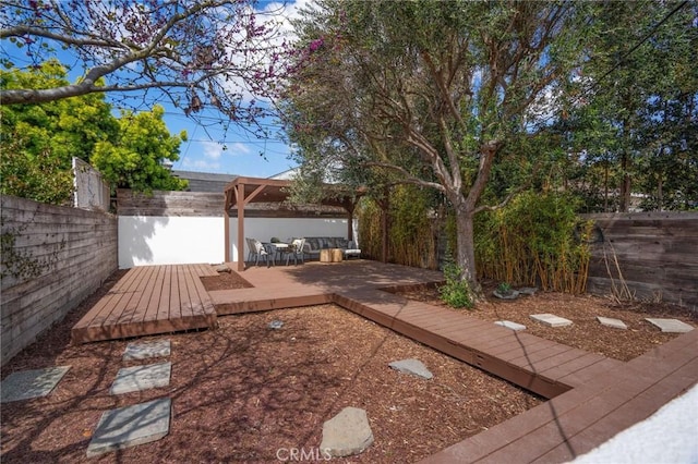 view of yard featuring a fenced backyard and a wooden deck