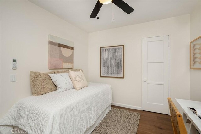 bedroom with baseboards, wood finished floors, and ceiling fan