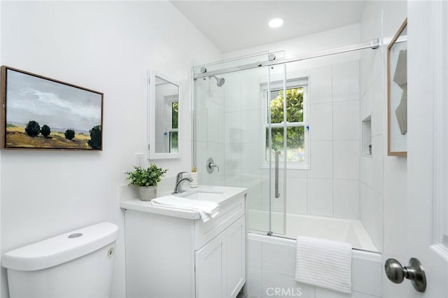 full bath with combined bath / shower with glass door, toilet, and vanity