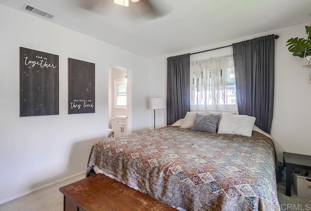 carpeted bedroom with visible vents, a ceiling fan, baseboards, and ensuite bathroom