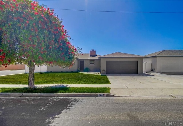 single story home featuring a chimney, stucco siding, concrete driveway, a front yard, and a garage