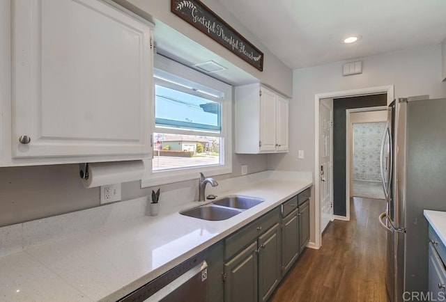 kitchen featuring white cabinets, a sink, dark wood-style flooring, freestanding refrigerator, and recessed lighting