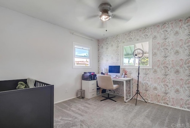 interior space with wallpapered walls, carpet, baseboards, and ceiling fan