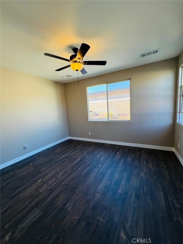 65565 Acoma Ave Unit 68, Desert Hot Springs, CA 92240 - empty room featuring dark wood-type flooring, visible vents, a ceiling fan, and a healthy amount of sunlight