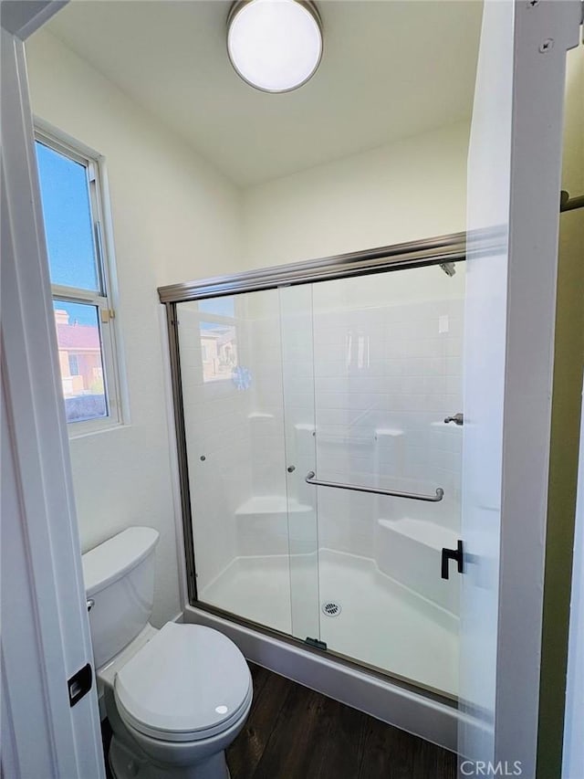 65565 Acoma Ave Unit 68, Desert Hot Springs, CA 92240 - bathroom featuring a shower stall, wood finished floors, and toilet