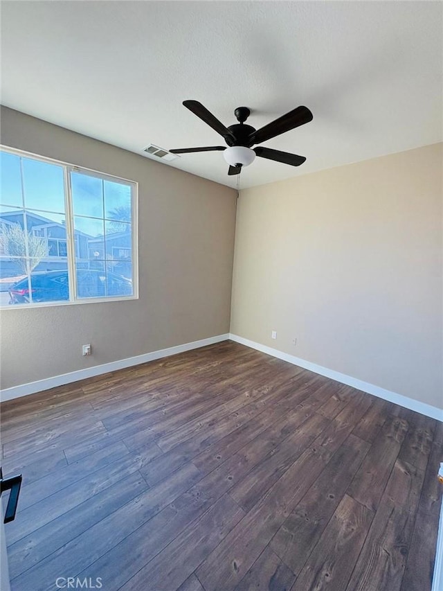65565 Acoma Ave Unit 68, Desert Hot Springs, CA 92240 - spare room with dark wood-type flooring, baseboards, a ceiling fan, and visible vents
