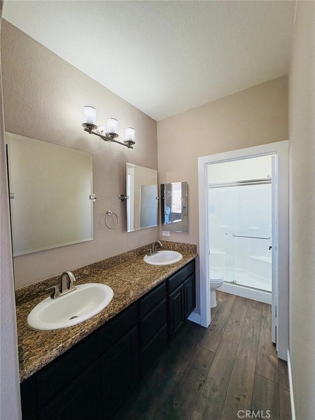 65565 Acoma Ave Unit 68, Desert Hot Springs, CA 92240 - bathroom featuring toilet, wood finished floors, a sink, and a shower