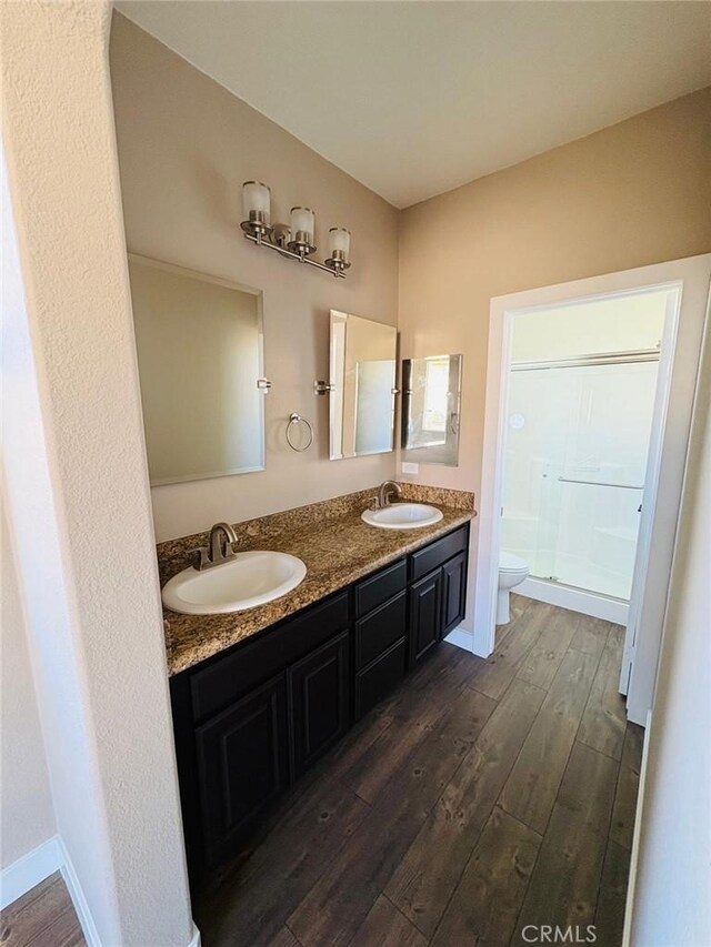 65565 Acoma Ave Unit 68, Desert Hot Springs, CA 92240 - bathroom featuring toilet, wood finished floors, a sink, and a shower