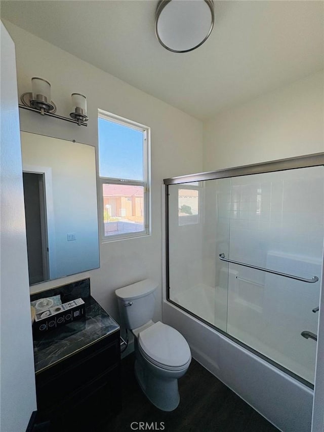 65565 Acoma Ave Unit 68, Desert Hot Springs, CA 92240 - bathroom featuring combined bath / shower with glass door, vanity, toilet, and wood finished floors