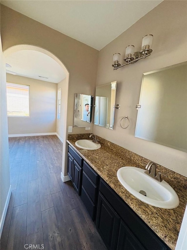 65565 Acoma Ave Unit 68, Desert Hot Springs, CA 92240 - bathroom with a sink, baseboards, double vanity, and wood finished floors