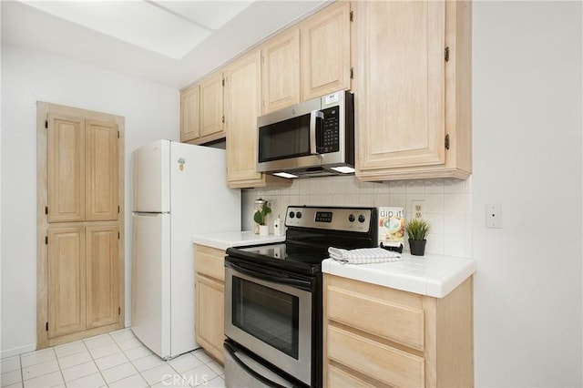 20702 El Toro Rd Unit 379, Lake Forest, CA 92630 - kitchen featuring stainless steel appliances, light brown cabinetry, backsplash, and tile countertops