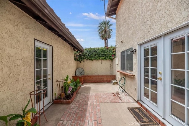 view of patio / terrace featuring french doors and fence