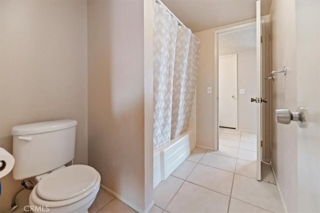 bathroom with tile patterned floors, toilet, and baseboards