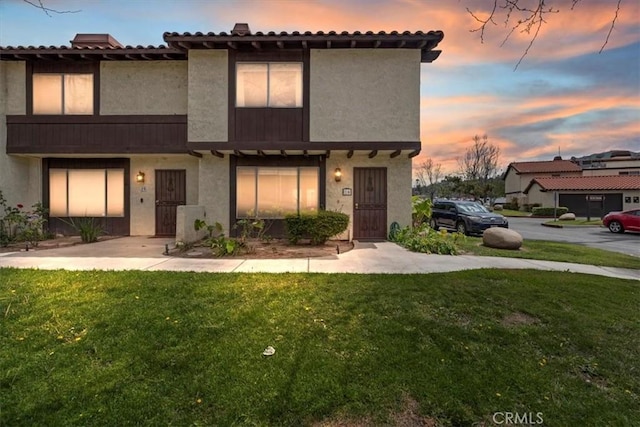 view of front of property with a front yard and stucco siding