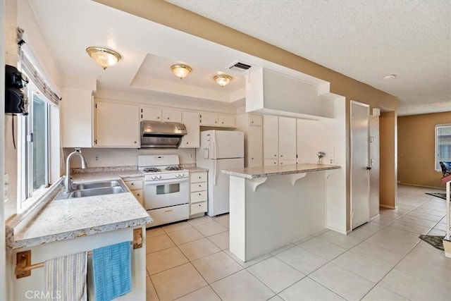 kitchen with light tile patterned floors, white appliances, a textured ceiling, visible vents, and a sink