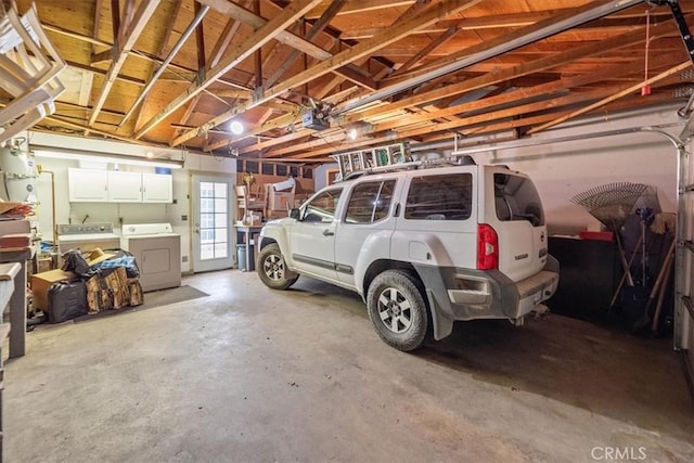 garage with separate washer and dryer and a garage door opener