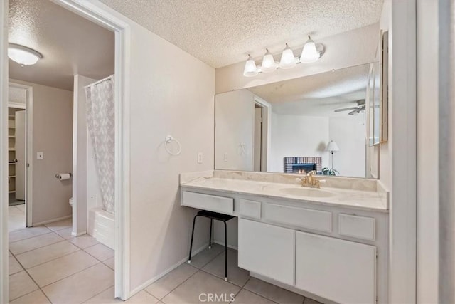 bathroom with a textured ceiling, a shower with curtain, ceiling fan, and tile patterned floors