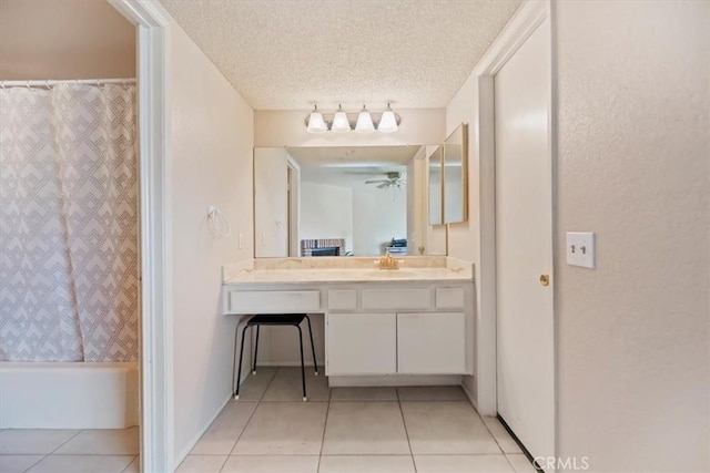 full bath with vanity, tile patterned flooring, a textured ceiling, ceiling fan, and shower / bath combo with shower curtain