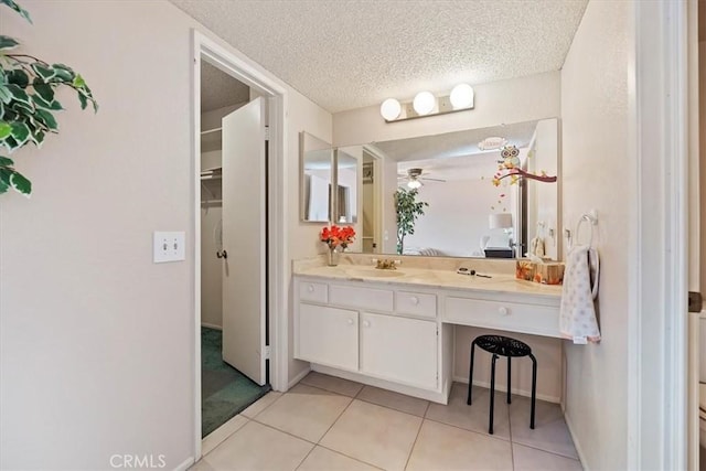 bathroom featuring a textured ceiling, vanity, ceiling fan, and tile patterned floors
