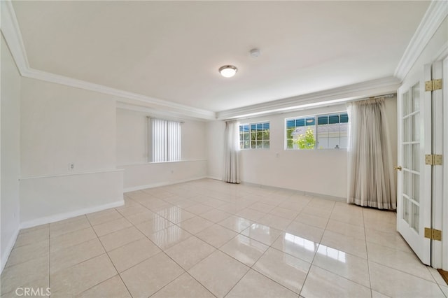 spare room with tile patterned floors, french doors, crown molding, and baseboards