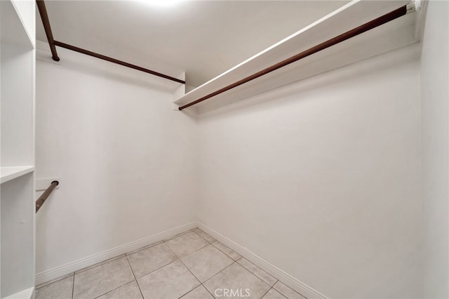 spacious closet with light tile patterned floors