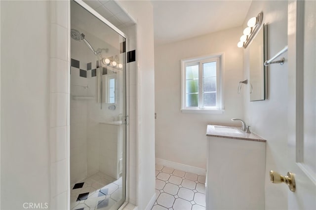 bathroom with vanity, baseboards, and a stall shower