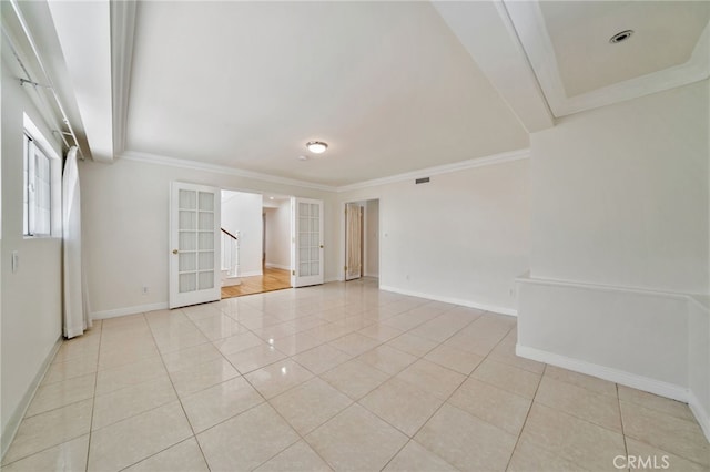 empty room featuring light tile patterned floors, ornamental molding, stairs, french doors, and baseboards
