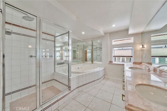 full bathroom featuring a sink, a shower stall, double vanity, tile patterned floors, and a garden tub