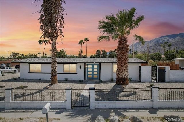845 W Gateway Dr, Palm Springs, CA 92262 - view of front facade with stucco siding, a mountain view, a gate, and a fenced front yard