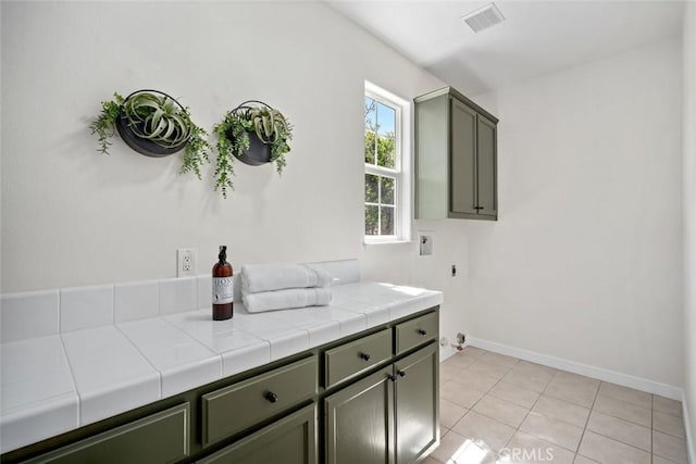 bathroom featuring baseboards, tile patterned flooring, and visible vents