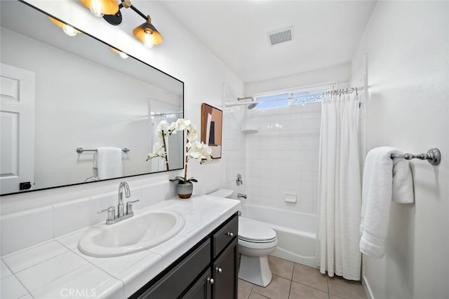 bathroom featuring visible vents, toilet, shower / bathtub combination with curtain, vanity, and tile patterned floors