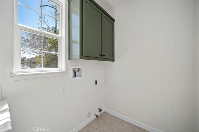 laundry area with cabinet space, a wealth of natural light, electric dryer hookup, and washer hookup