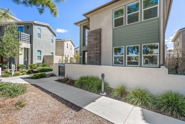 120 Zawn, Irvine, CA 92618 - view of side of home with stucco siding and fence
