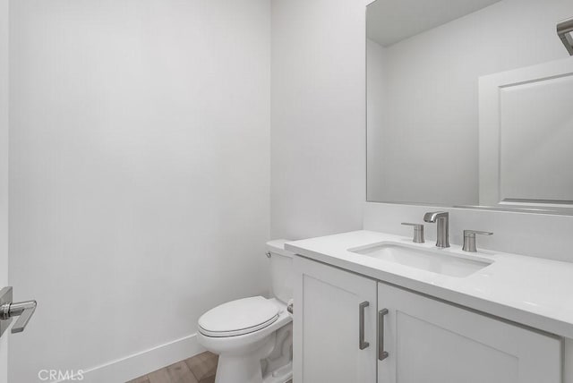 120 Zawn, Irvine, CA 92618 - half bathroom featuring vanity, baseboards, toilet, and wood finished floors