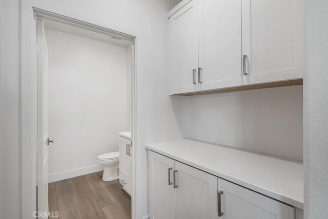 120 Zawn, Irvine, CA 92618 - bathroom with vanity, baseboards, toilet, and wood finished floors