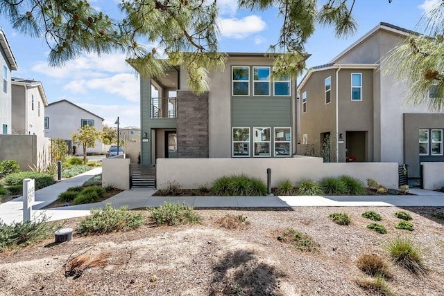 120 Zawn, Irvine, CA 92618 - view of front of home with a residential view, a balcony, and stucco siding