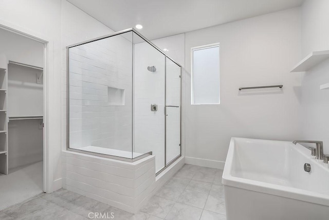 120 Zawn, Irvine, CA 92618 - bathroom with a shower stall, a walk in closet, a bathtub, and baseboards