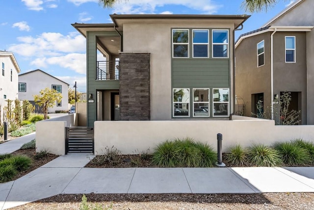 120 Zawn, Irvine, CA 92618 - view of front facade with a balcony, stucco siding, and a fenced front yard