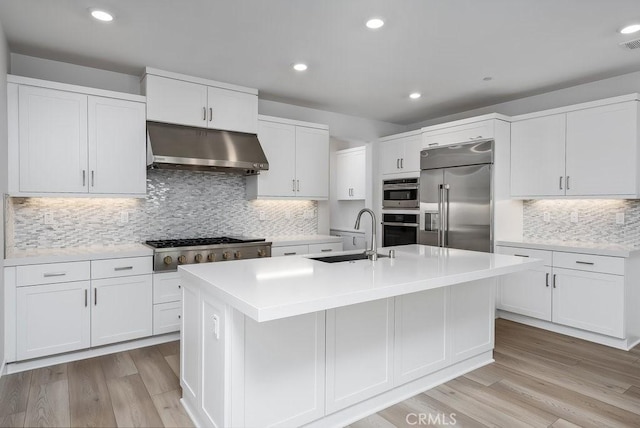 120 Zawn, Irvine, CA 92618 - kitchen featuring light countertops, white cabinetry, under cabinet range hood, stainless steel appliances, and a sink