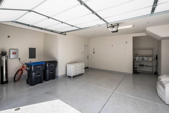 120 Zawn, Irvine, CA 92618 - garage featuring a garage door opener, baseboards, and electric panel