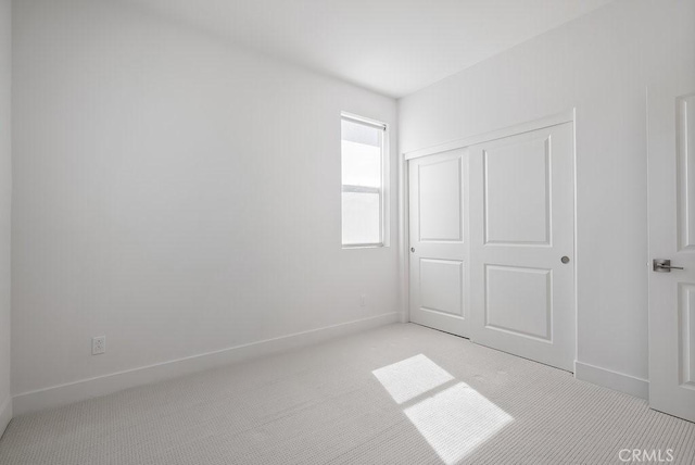 120 Zawn, Irvine, CA 92618 - unfurnished bedroom featuring a closet, light colored carpet, and baseboards